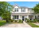 Charming two-story home with a well-manicured lawn, covered porch, and classic architectural details at 9049 Parlor Dr, Ladson, SC 29456