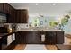 Open kitchen area with granite counters, stainless steel appliances, and warm lighting at 9049 Parlor Dr, Ladson, SC 29456