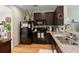 Well-equipped kitchen with stainless steel sink, granite countertops, and sleek dark brown cabinetry at 9049 Parlor Dr, Ladson, SC 29456