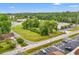 Aerial shot of a commercial lot featuring mature trees and a surrounding neighborhood landscape at 9612 Hoot Owl Ave, Ladson, SC 29456