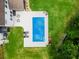 Aerial view showcases the backyard pool, patio, and lush lawn, highlighting outdoor living at 9713 Cutleaf Dr, Ladson, SC 29456