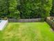 Aerial view of a large, fenced backyard with lush green grass and mature trees at 9713 Cutleaf Dr, Ladson, SC 29456