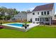 Relaxing backyard with a pristine pool, screened porch, and ample lounge space at 9713 Cutleaf Dr, Ladson, SC 29456
