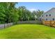 Expansive backyard with lush green lawn and privacy fence is perfect for outdoor activities and relaxation at 9713 Cutleaf Dr, Ladson, SC 29456