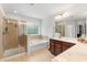 Well-lit bathroom featuring a glass-enclosed shower, a soaking tub, and a double sink vanity at 9713 Cutleaf Dr, Ladson, SC 29456