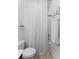 Functional bathroom features a toilet, shower with curtain, and minimalist decor at 9713 Cutleaf Dr, Ladson, SC 29456