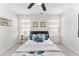 Comfortable bedroom featuring a ceiling fan, large bed, and two windows with blinds at 9713 Cutleaf Dr, Ladson, SC 29456