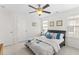 Bedroom with a ceiling fan, large bed, and two windows with blinds at 9713 Cutleaf Dr, Ladson, SC 29456