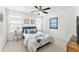 Bright bedroom with large bed, side table, and two windows with blinds at 9713 Cutleaf Dr, Ladson, SC 29456