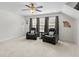 Spacious bonus room featuring plush chairs and a ceiling fan for ultimate comfort and relaxation at 9713 Cutleaf Dr, Ladson, SC 29456