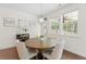 Dining area features a wooden table, chairs, ample natural light and backyard view, perfect for Gathering meals at 9713 Cutleaf Dr, Ladson, SC 29456