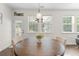 Bright dining area features a round wooden table, chairs, natural light, and a view of the backyard at 9713 Cutleaf Dr, Ladson, SC 29456