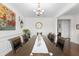 Elegant dining room with a chandelier, large table, and decorative wall art at 9713 Cutleaf Dr, Ladson, SC 29456