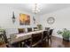 Elegant dining room features a chandelier, decorative wall art, and dark wood table with seating for eight at 9713 Cutleaf Dr, Ladson, SC 29456