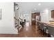 Hallway with hardwood floors leading to an open-concept kitchen with bar stool seating at 9713 Cutleaf Dr, Ladson, SC 29456