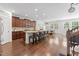Spacious kitchen boasts a large island with seating, granite countertops, and modern appliances, leading to the dining area at 9713 Cutleaf Dr, Ladson, SC 29456