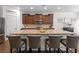 Close-up of kitchen island featuring granite countertops, seating for four, and ample storage with modern cabinetry at 9713 Cutleaf Dr, Ladson, SC 29456