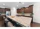 Modern kitchen showcases a large granite island with seating, stainless steel appliances, and custom wood cabinetry at 9713 Cutleaf Dr, Ladson, SC 29456
