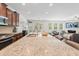 Open-concept kitchen with a large island featuring granite countertops, stainless steel appliances, and ample seating at 9713 Cutleaf Dr, Ladson, SC 29456
