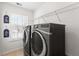 Modern laundry room featuring energy-efficient appliances and storage shelving at 9713 Cutleaf Dr, Ladson, SC 29456