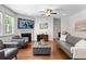 Comfortable living room with hardwood floors and modern gray sofa, ottoman, and chairs at 9713 Cutleaf Dr, Ladson, SC 29456
