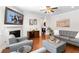 Inviting living room featuring hardwood floors, a modern sofa, and decorative fireplace at 9713 Cutleaf Dr, Ladson, SC 29456