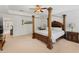 Comfortable main bedroom with a canopy bed, bedside tables, and natural light, creating a serene retreat at 9713 Cutleaf Dr, Ladson, SC 29456