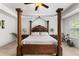 Luxurious main bedroom with a canopy bed, bedside tables, lamps, and an exercise bike at 9713 Cutleaf Dr, Ladson, SC 29456