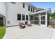Back of house with patio featuring a screened in porch, seating, and rock feature at 9713 Cutleaf Dr, Ladson, SC 29456