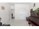 Well-lit room with piano, neutral carpet, and view to the hallway with double door access at 9713 Cutleaf Dr, Ladson, SC 29456