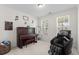 Bright room with piano, massage chair, carpet, and windows offering a view to the outdoors at 9713 Cutleaf Dr, Ladson, SC 29456