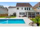 Aerial view of backyard pool, chairs, and patio at 9713 Cutleaf Dr, Ladson, SC 29456