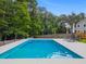 Backyard pool with lounge chairs and lush greenery at 9713 Cutleaf Dr, Ladson, SC 29456