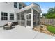A screened in porch with an exterior view of the backyard's rock garden and patio area at 9713 Cutleaf Dr, Ladson, SC 29456