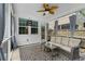 Enclosed back porch offers a seating area, ceiling fan, and view of the outdoors at 9713 Cutleaf Dr, Ladson, SC 29456
