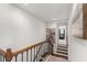Upstairs landing featuring a staircase with wooden railings and carpeted steps at 9713 Cutleaf Dr, Ladson, SC 29456