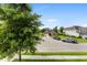 Street view of home featuring well-maintained lawn, landscaping, and driveway with two pickup trucks parked at 9713 Cutleaf Dr, Ladson, SC 29456