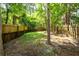 View of a fenced-in backyard with mature trees, minimal grass and wooden fencing at 102 Sandy Hook Ct, Summerville, SC 29486