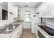 Functional kitchen with white appliances, tile floor, and stainless steel sink at 102 Sandy Hook Ct, Summerville, SC 29486