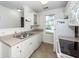 Functional kitchen with white appliances, tile floor, and stainless steel sink at 102 Sandy Hook Ct, Summerville, SC 29486
