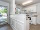 Bright kitchen with white cabinets and appliances, plus convenient eat-in bar at 102 Sandy Hook Ct, Summerville, SC 29486