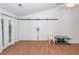 Bright living room with sliding barn door and glass-topped table at 102 Sandy Hook Ct, Summerville, SC 29486