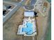 Aerial shot captures the neighborhood pool, lounge chairs, and the manicured landscaping surrounding the amenity at 104 Wild Orchid Way, Huger, SC 29450