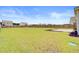 Spacious, grassy backyard with a wooden fence, offering ample space for recreation and privacy at 104 Wild Orchid Way, Huger, SC 29450