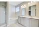 Well-lit bathroom with double sink vanity, a soaking tub, and a glass-enclosed shower at 104 Wild Orchid Way, Huger, SC 29450