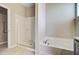 Clean bathroom featuring a shower with glass door and a soaking tub, promoting relaxation at 104 Wild Orchid Way, Huger, SC 29450