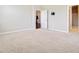 Spacious bedroom with neutral carpet, a wall-mounted TV bracket, and doorways leading to other rooms at 104 Wild Orchid Way, Huger, SC 29450