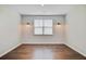 Bedroom with hardwood flooring, plank accent wall, and sconce lighting at 104 Wild Orchid Way, Huger, SC 29450