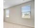 Bedroom with neutral carpet and walls, featuring two windows with blinds and natural light at 104 Wild Orchid Way, Huger, SC 29450