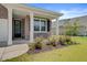 Inviting front porch with white columns, bench, and well-landscaped garden at 104 Wild Orchid Way, Huger, SC 29450